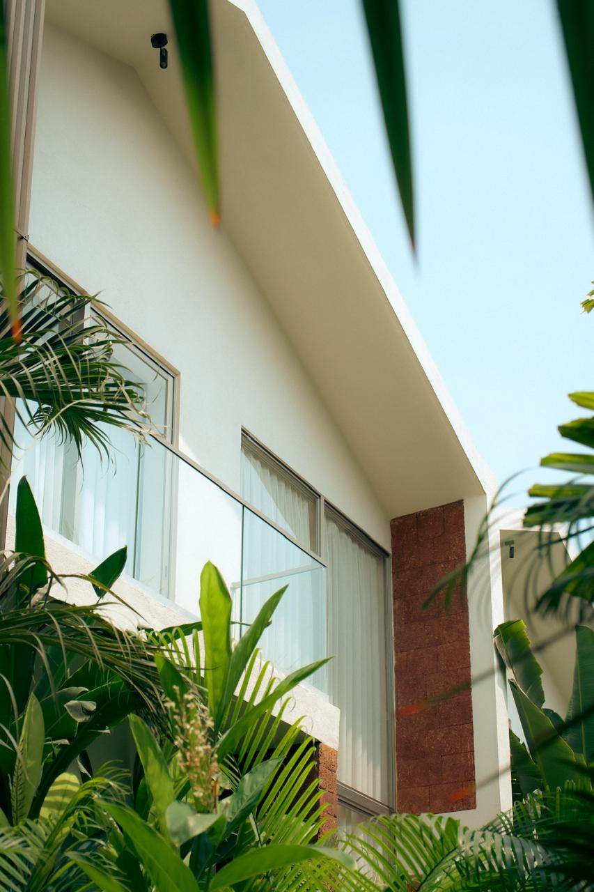 Aura Stays villa exterior framed by tropical greenery